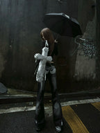 Distressed white DEADLOOM Cross Bag worn on a rainy street