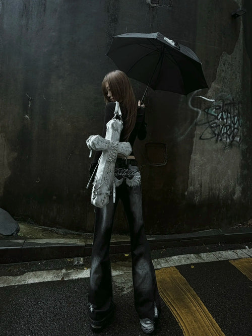Distressed white DEADLOOM Cross Bag worn on a rainy street