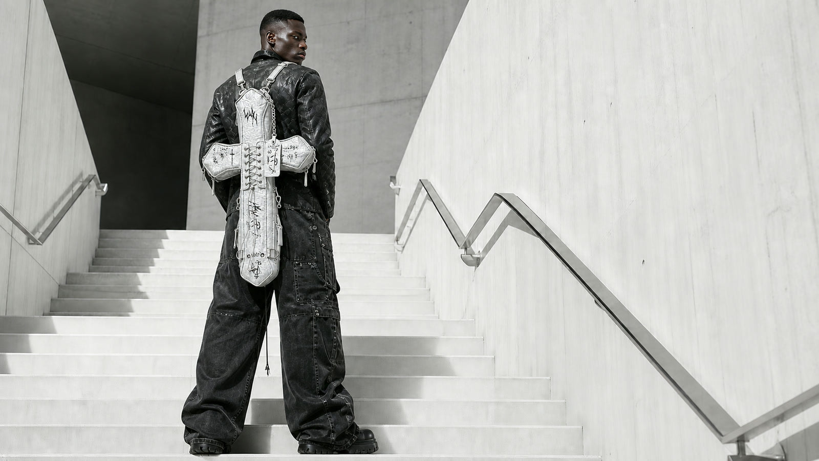 Distressed White DEADLOOM Cross Bag worn in a full-body campaign view