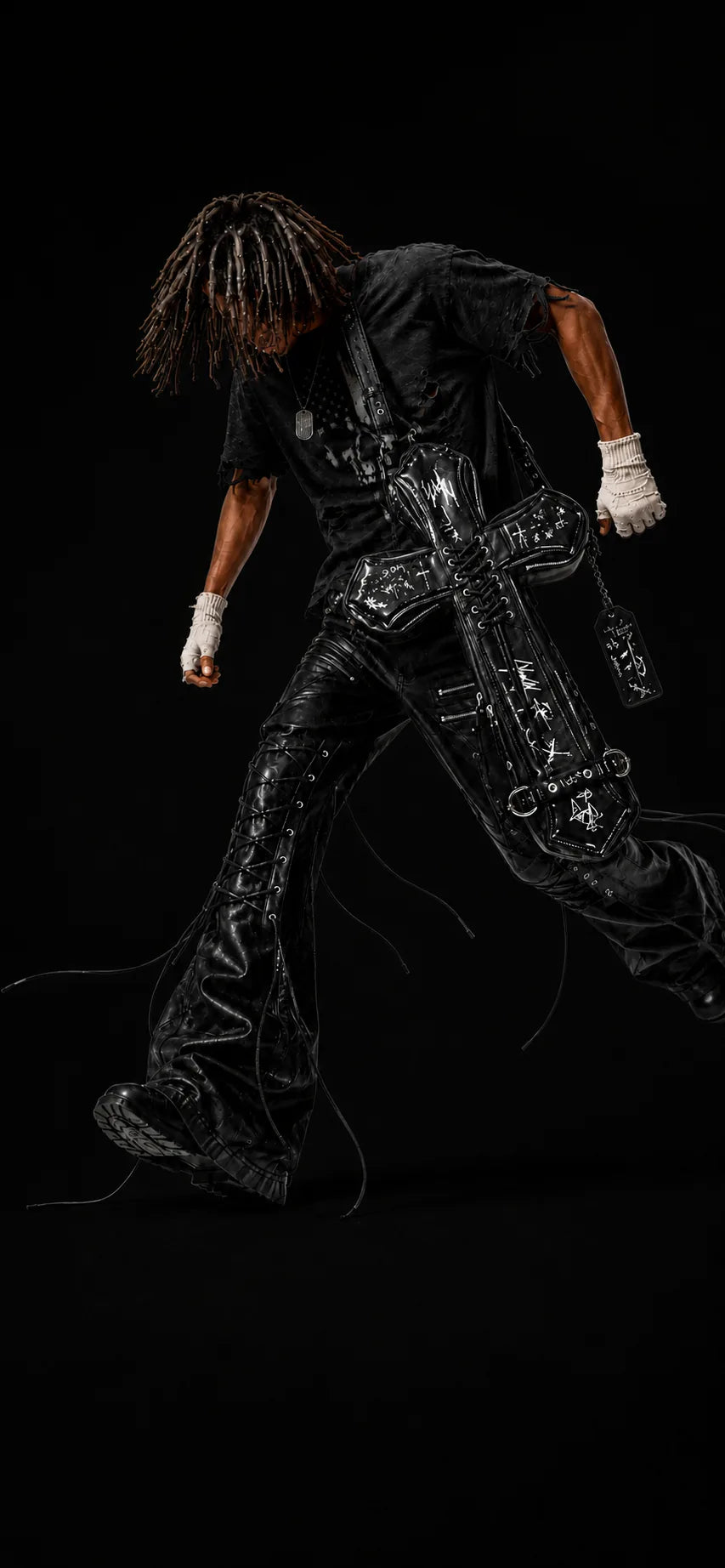 Model wearing the DEADLOOM Cross Bag in Black; drag the center line to reveal Distressed White